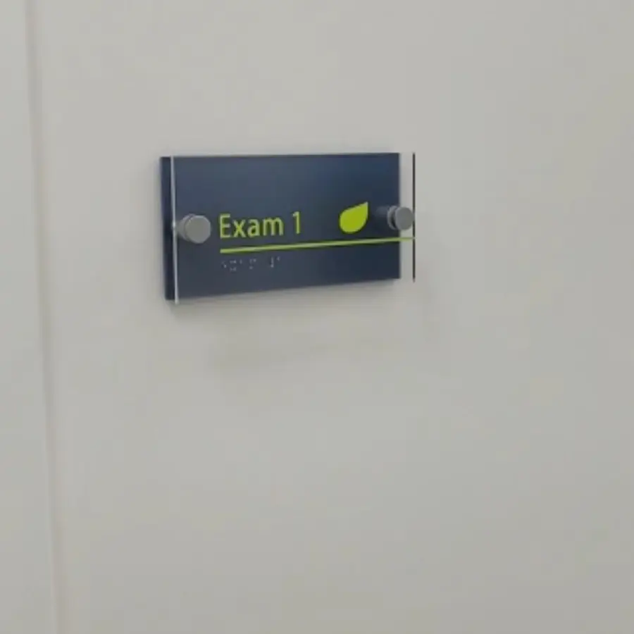 ADA room sign for Exam 1 with braille