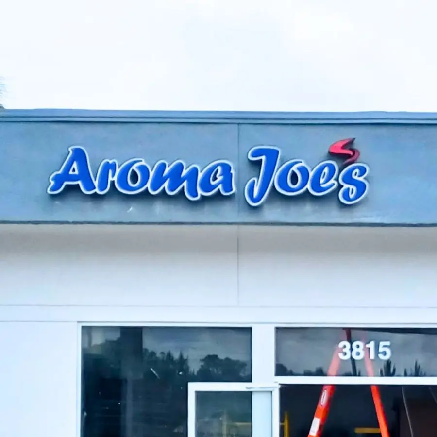 Aroma Joe's storefront during installation, with a ladder