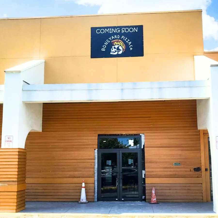 Boneyard Pizza coming soon banner on a storefront