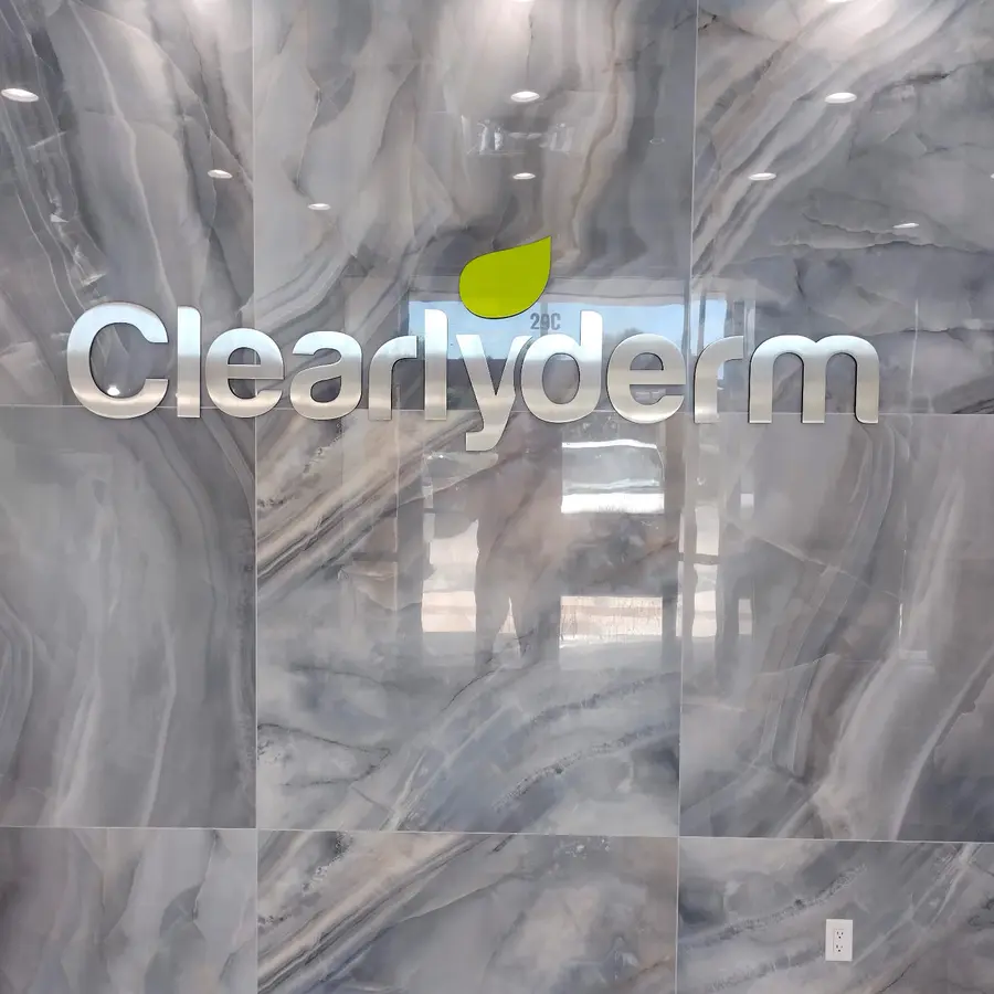 Illuminated letters on a marble lobby wall