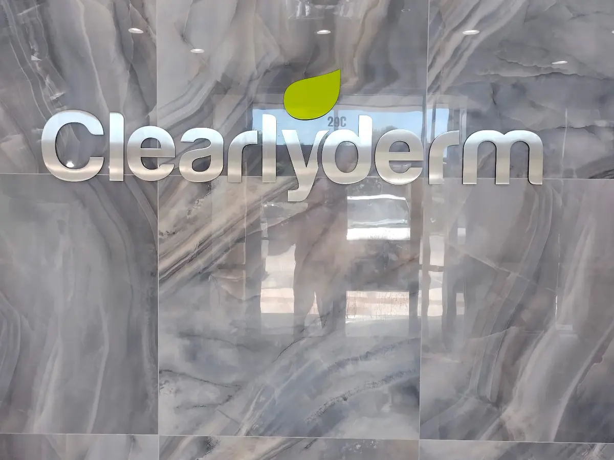Illuminated letters on a marble lobby wall