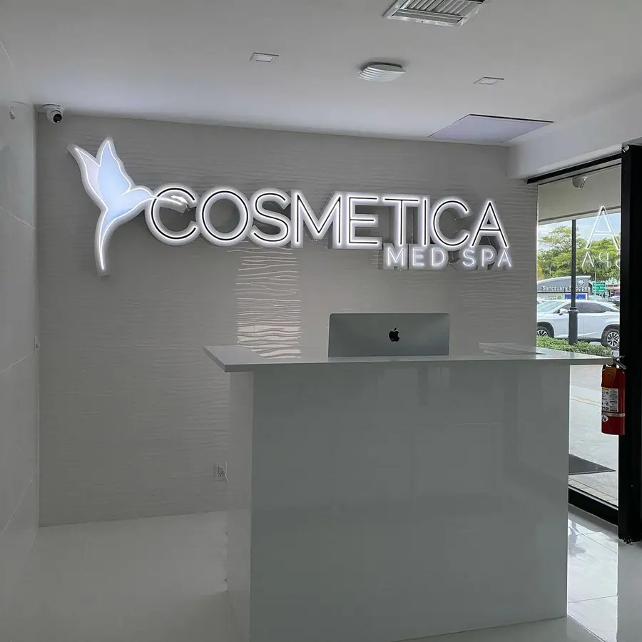 Cosmetica Med Spa reception with illuminated logo letters