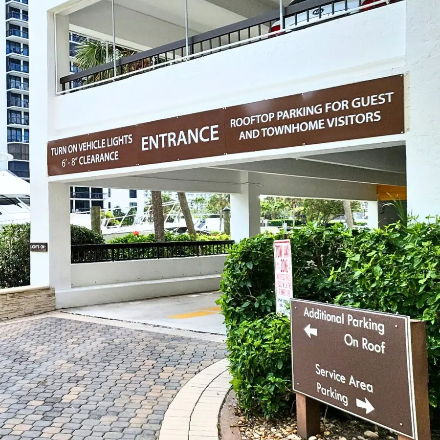 Parking garage entrance sign with clearance and directional panels
