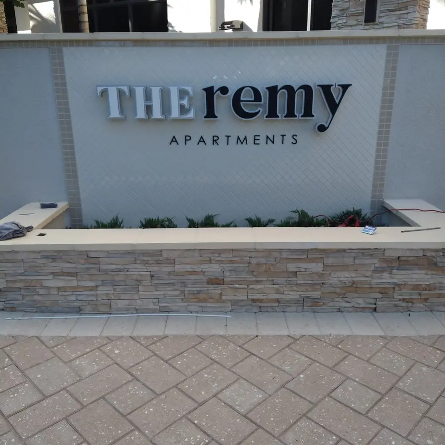 THE remy Apartments monument sign with stone base