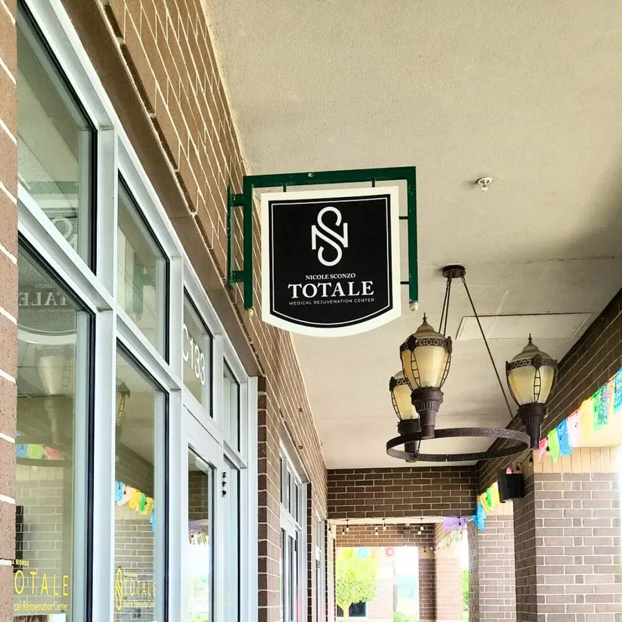 Totale hanging blade sign under a walkway